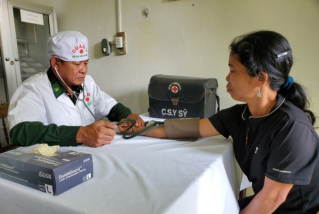 Thiếu tá, y sĩ Bùi Công Trọng khám bệnh cho chị A Viết Thị Thôn, 40 tuổi, đến từ bản Ka Lôi, H.Ka Lùm (Lào) Thiếu tá, y sĩ Bùi Công Trọng khám bệnh cho chị A Viết Thị Thôn, 40 tuổi, đến từ bản Ka Lôi, H.Ka Lùm (Lào)