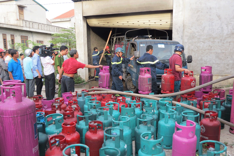 Vận chuyển hàng trăm bình gas bị khói lửa nhuốm đen ra khỏi khu vụ kho gas bị cháy nổ. Ảnh: Bùi Oanh Vận chuyển hàng trăm bình gas bị khói lửa nhuốm đen ra khỏi khu vụ kho gas bị cháy nổ. Ảnh: Bùi Oanh