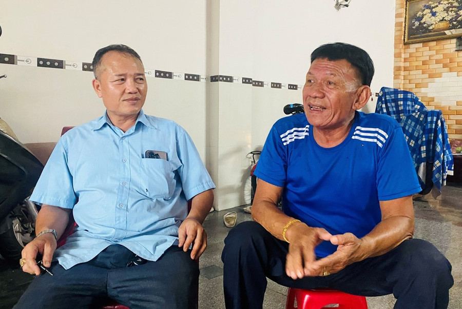 Ông Phan Trọng Bình (bìa trái) gặp chủ tàu Trần Kim Cư để nhắc nhở về thời hạn các giấy tờ và phổ biến một số quy định mới liên quan đến việc đăng ký, đăng kiểm tàu cá. Ảnh: N.N 81.jpg