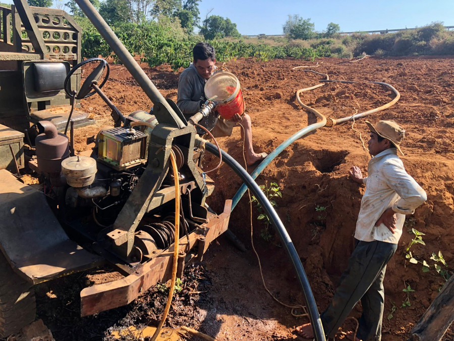 Người dân xã Ia Sao, huyện Ia Grai lắp đặt máy bơm để tưới nước cho cây cà phê. Ảnh: Lê Nam