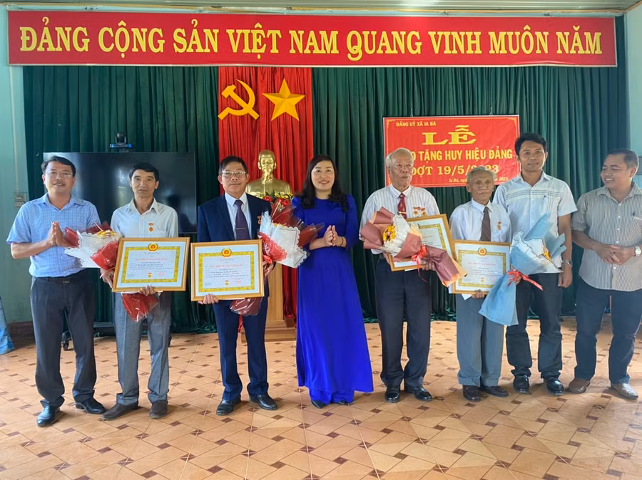 Phó Bí thư Thường trực Huyện ủy Nguyễn Thị Lành-Phó Bí thư Thường trực Huyện ủy Ia Grai trao huy hiệu Đảng cho 4 đảng viên xã Ia Bă. Ảnh: Phương Lộc