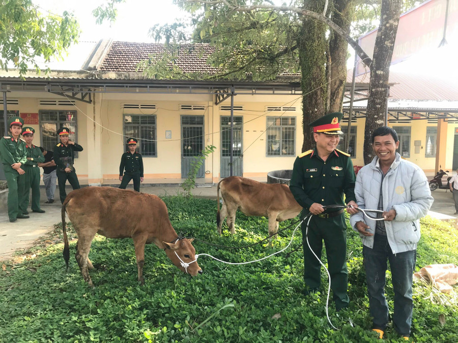 Đại diện Trung đoàn 38 trao bò cho hộ nghèo xã Ya Hội. Ảnh: Lan Anh