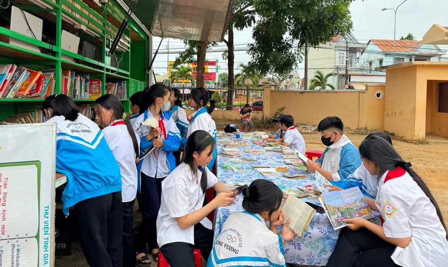 Các em học sinh đọc sách tại ngày hội. Ảnh: Minh Thoan