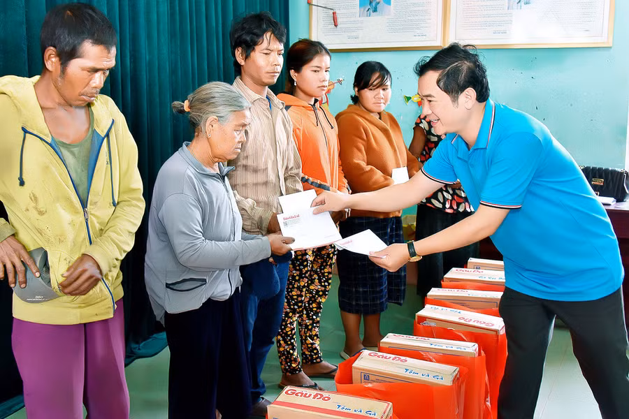 Phó Tổng biên tập Báo Gia Lai Đoàn Minh Dưỡng-Bí thư Chi bộ 3 tặng quà cho hộ nghèo làng Kon Brung. Ảnh: Đ.T