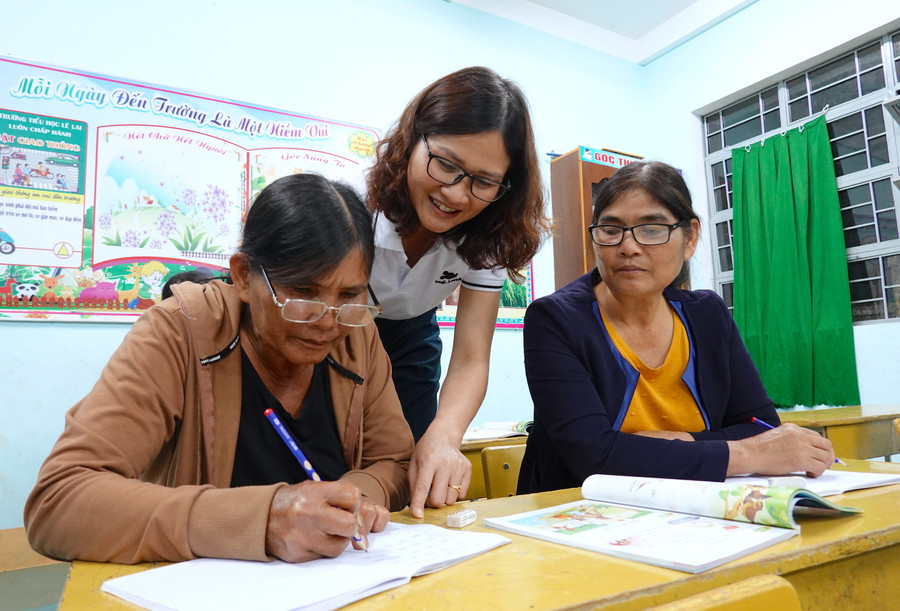 Cô Đỗ Thị Lan (giữa)-giáo viên Trường Tiểu học Lê Lai (xã Chư Á, TP. Pleiku) hướng dẫn học viên viết chữ. Ảnh: Mộc Trà