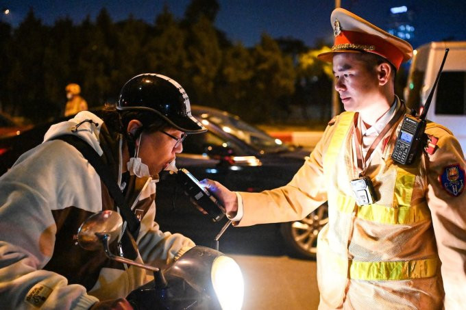 CSGT kiểm tra nồng độ cồn người đi xe máy. Ảnh: H.Q