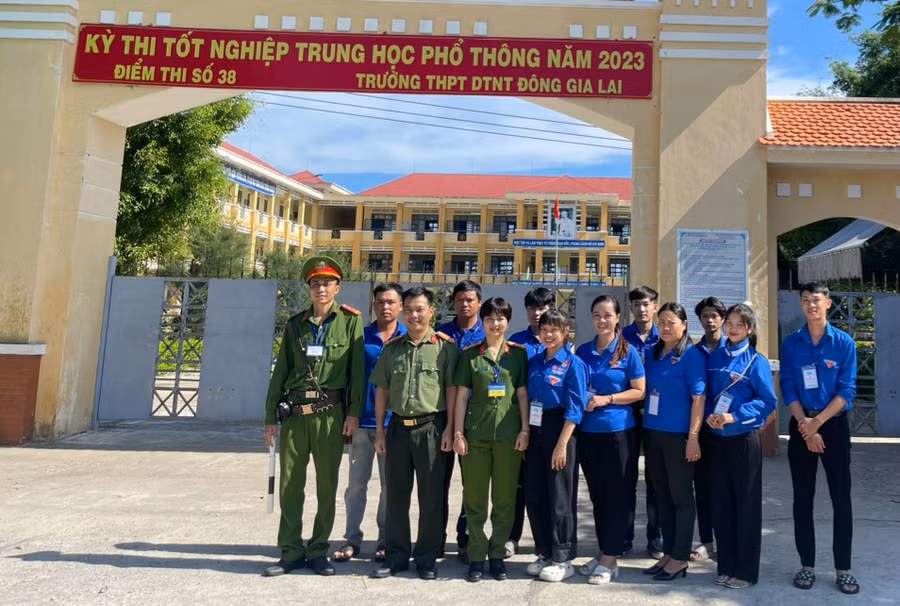 Trung tá Ksor H'Bơ Khắp-Phó Giám đốc Công an tỉnh Gia Lai chụp hình lưu niệm với lực lượng Công an và các tình nguyện viên tại điểm thi số 38. Ảnh: Hạ Vy