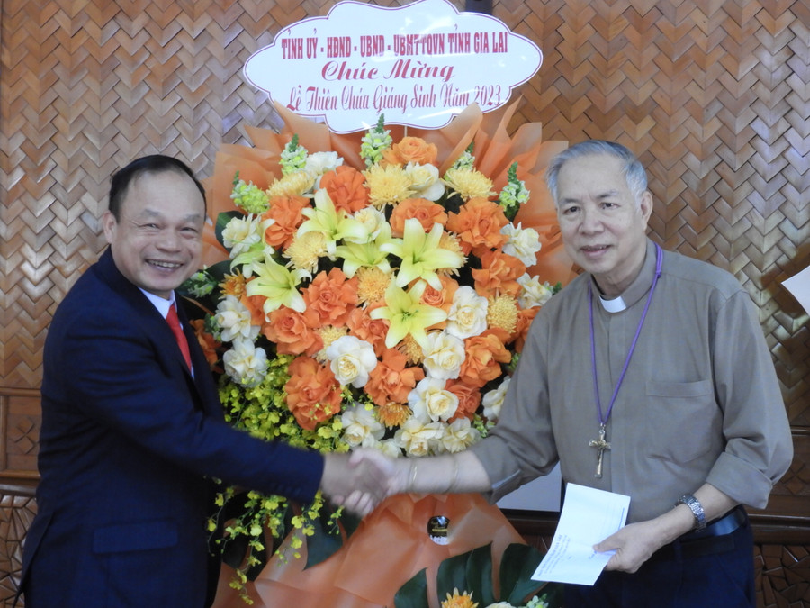 Phó Chủ tịch UBND tỉnh Gia Lai Dương Mah Tiệp (trái) tặng hoa chúc mừng Giáng sinh tại Toà Giám mục Giáo phận Kon Tum. Ảnh Thanh Nhật