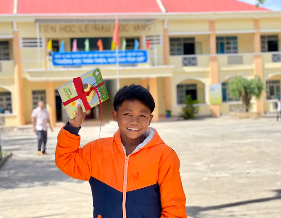 Cậu học trò Bahnar Trường Phổ thông Dân tộc bán trú THCS Trần Kiên vui mừng với phần thưởng sau lễ sơ kết học kỳ I. Ảnh: Lam Nguyên