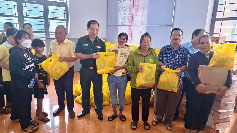 Đại diện Ban Chỉ huy Quân sự huyện Đức Cơ và Hội LHPN Phường 6 (Quận 8, TP. Hồ Chí Minh) tặng quà các gia đình có hoàn cảnh khó khăn xã Ia Lang. Ảnh: Kim Hồng