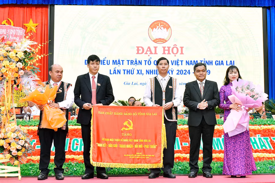 Bí thư Tỉnh ủy Hồ Văn Niên (thứ 2 từ phải sang) trao tặng bức trướng với nội dung: “Ủy ban MTTQ Việt Nam tỉnh Gia Lai “Đoàn kết-Dân chủ-Trách nhiệm-Đổi mới-Phát triển””. Ảnh: Đ.T