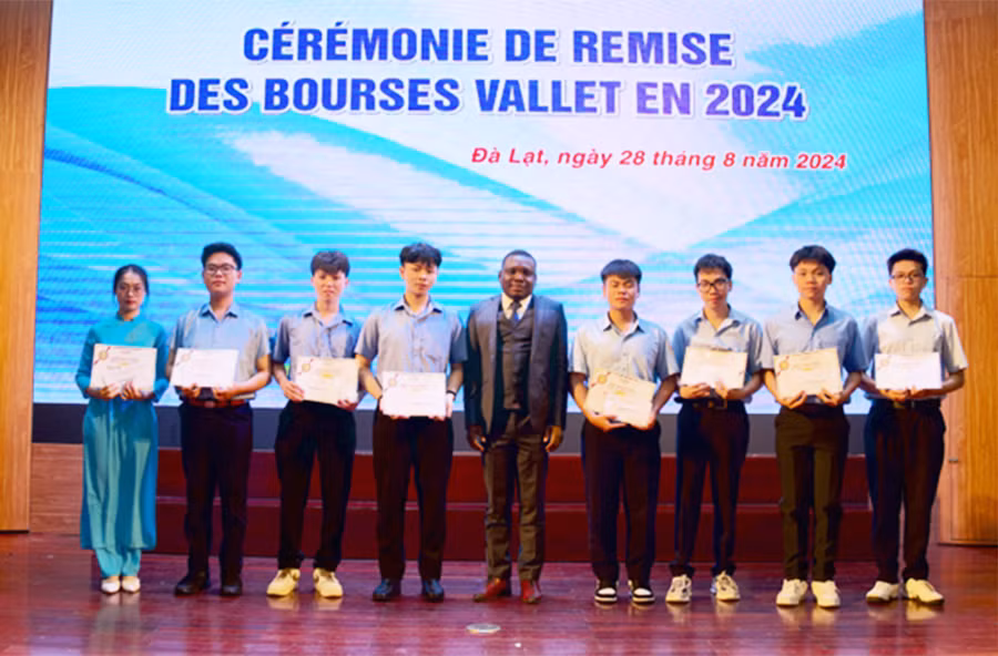 Ông Esperan Padonou-Giám đốc Quỹ học bổng Vallet trao học bổng cho các em học sinh. Ảnh: Trương Quang