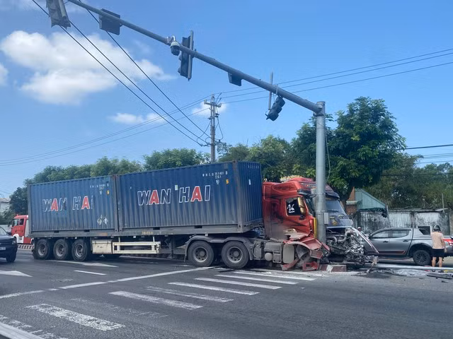 Xe container mất lái, lao vào trụ đèn giao thông khiến 2 người bị thương