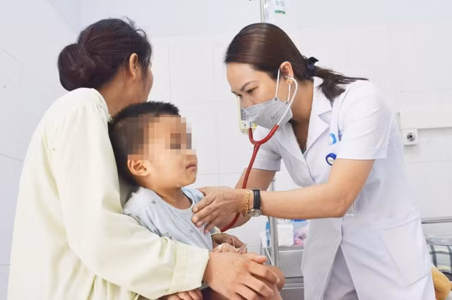 Bé trai 2 tuổi đi cấp cứu vì ngộ độc do uống nhầm lọ thuốc tẩy mụn - Ảnh 1. Bác sĩ đang thăm khám cho bệnh nhi 2 tuổi bị ngộ độc do uống nhầm thuốc tẩy mụn ruồi. Ảnh: BVCC