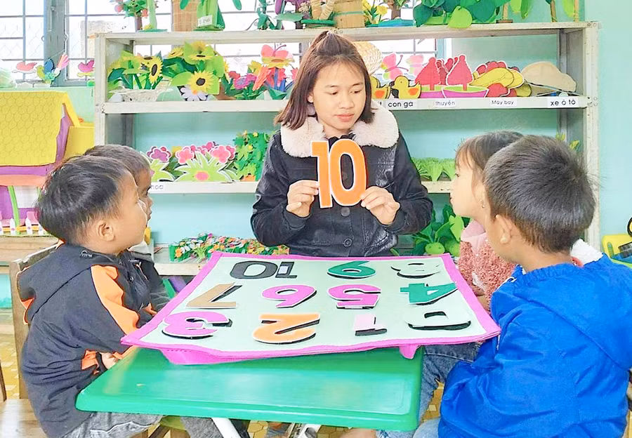 Giáo viên Trường Mẫu giáo Đak Rong (xã Đak Rong, huyện Kbang) hướng dẫn trẻ làm quen với số đếm. Ảnh: Mộc Trà