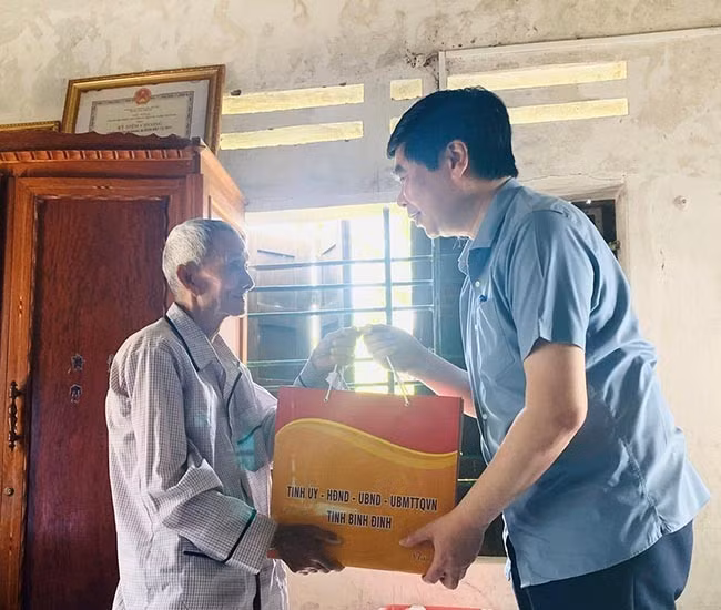Thương binh Đoàn Văn Trọng (bìa trái, nguyên là chiến sĩ Sư đoàn 3 Sao Vàng) xúc động khi đoàn đến thăm, khẳng định luôn một lòng theo Đảng, theo Bác Hồ. Ảnh: N.T