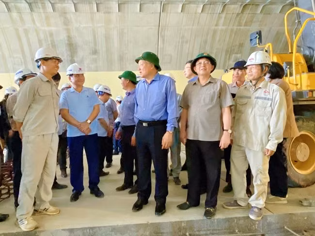 Phó Thủ tướng Thường trực Chính phủ Nguyễn Hòa Bình (thứ 3 từ phải sang), nghe nhà thầu báo cáo tiến độ thực hiện tại hầm Sơn Triệu. Ảnh: HẢI YẾN