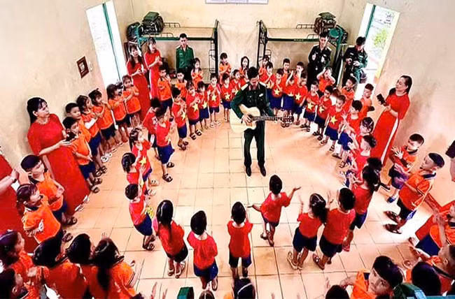 Cô và cháu Trường Mầm mon Sao Mai (thị trấn Phù Mỹ, huyện Phù Mỹ) giao lưu văn nghệ cùng bộ đội Lữ đoàn 572. Ảnh: QUANG THẮNG