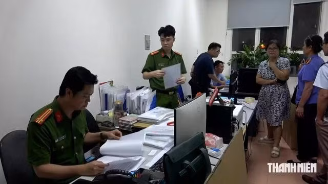 Cảnh sát khám xét nơi làm việc của bị can. Ảnh: Hà Cường