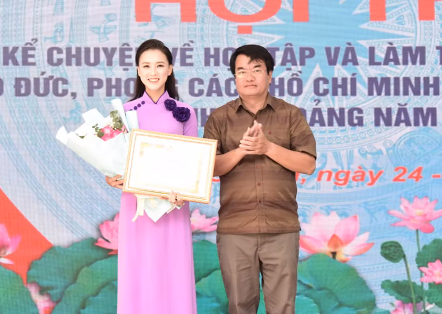 Đồng chí Tống Thới Mốc (bìa phải)-Phó Trưởng ban Thường trực Ban Tuyên giáo Tỉnh ủy trao giải nhất cho thí sinh Đặng Thị Hoài Thương. Ảnh: Đức Thụy