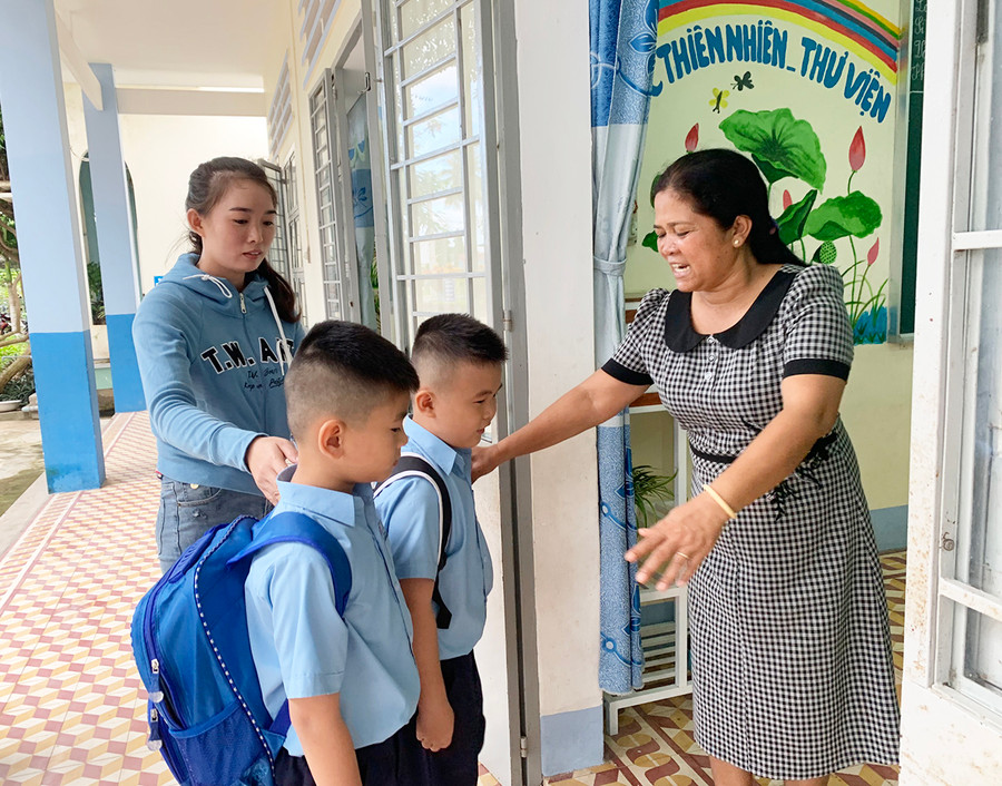 Chị Trương Thị Thu Hà (bìa trái; thôn Quý Tân, xã Ia Trok, huyện Ia Pa) quyết định nghỉ một buổi chợ để dẫn con đến lớp trong ngày tựu trường. Ảnh Vũ Chi