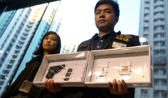 Súng, đạn thu được từ nghi phạm. Ảnh: SCMP