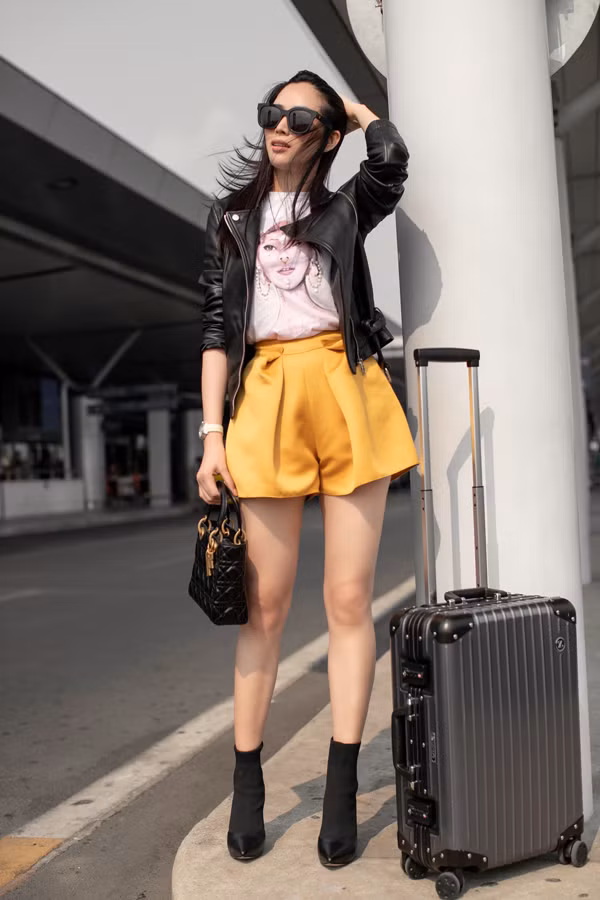 Jacket da đen được người đẹp chọn lựa để sử dụng cùng áo thun in họa tiết, short lụa màu vàng rực rỡ.