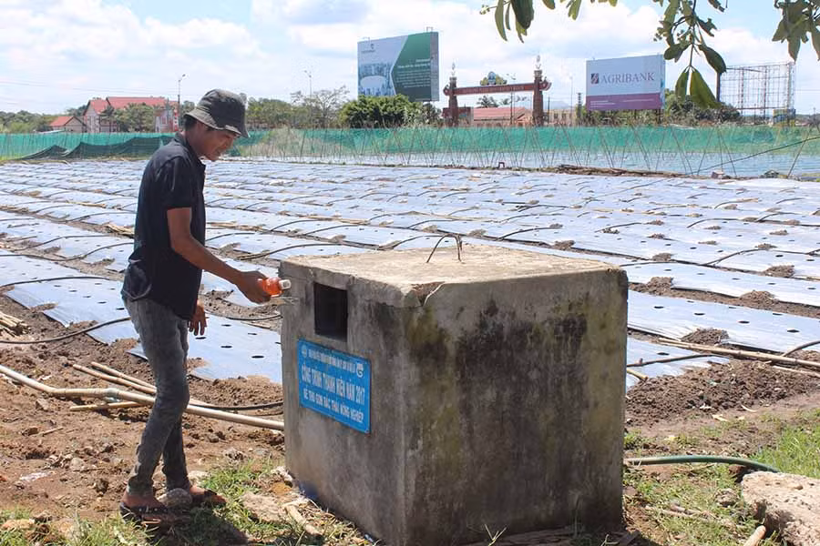  Người dân xã An Phú (TP. Pleiku) bỏ bao bì thuốc bảo vệ thực vật sau khi sử dụng vào bể chứa trên cánh đồng. Ảnh: N.D