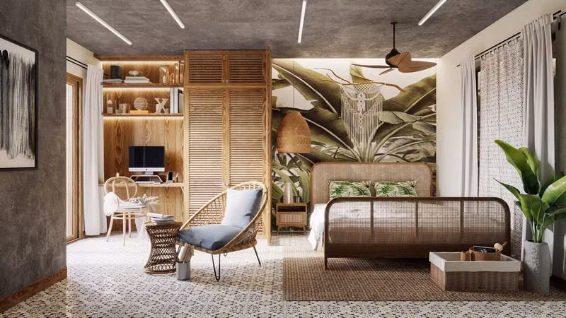 Một phòng ngủ mang chủ đề về rừng nhiệt đới với các mảng màu xanh được thêm thắt vừa đủ trên tường và phía cuối giường.