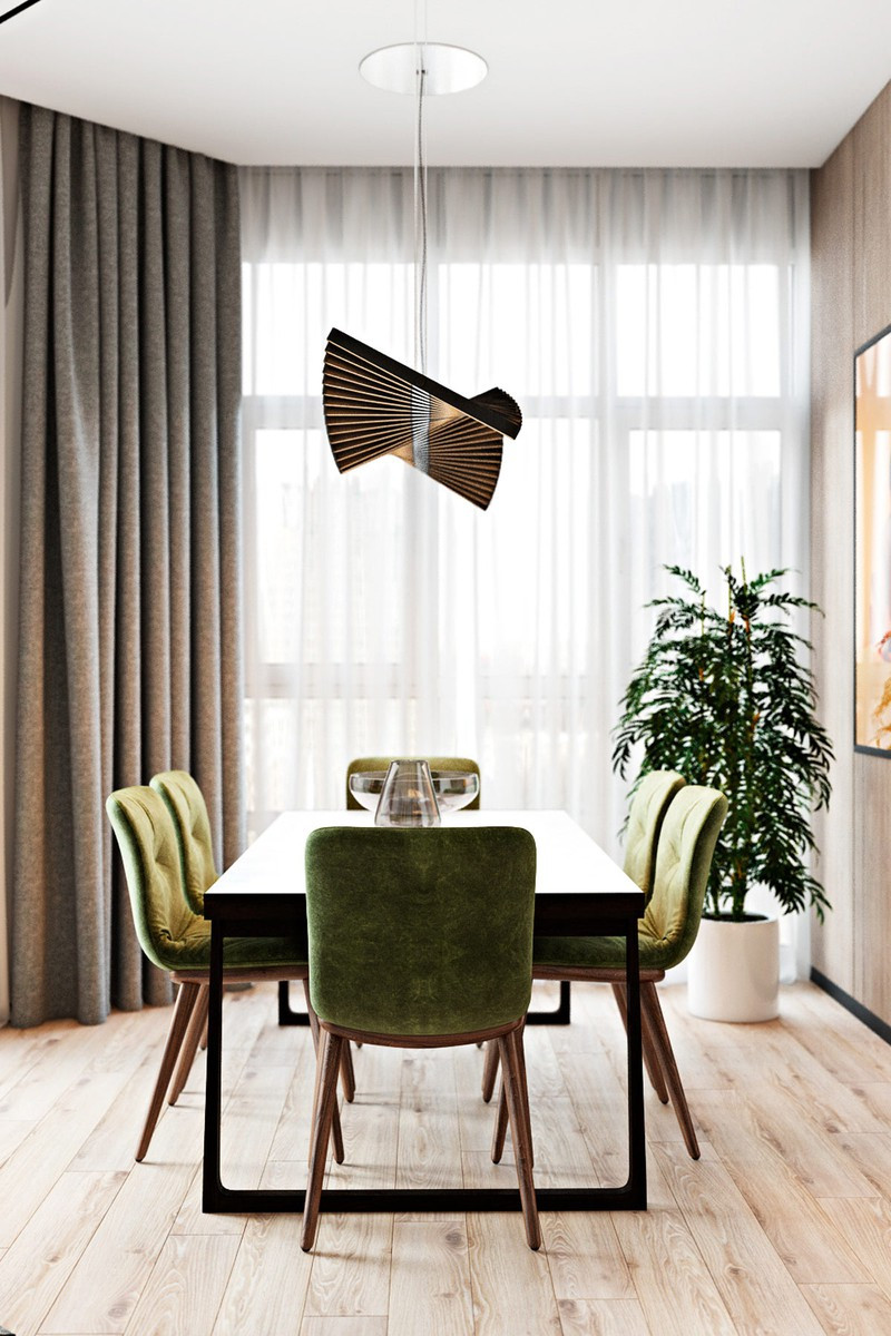 Ghế bọc nệm màu xanh mang đến cảm giác yên bình, gần gũi trong căn hộ.