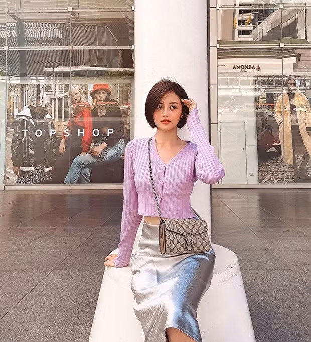 Sắc tím phấn nhẹ nhàng còn được Thùy Anh ưu ái với cardigan dáng lửng, phối cùng chân váy ánh bạc và túi Gucci duyên dáng.