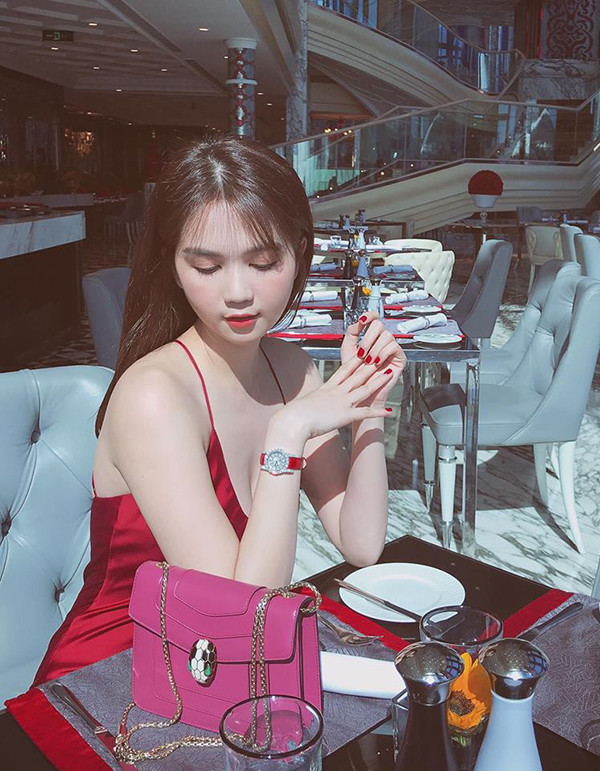 Váy hai dây màu đỏ thắm của Ngọc Trinh là trang phục vượt trội về khoản tôn làn da trắng. Khi sử dụng mẫu váy này để hẹn hò cà phê cùng bạn bè, các nàng cũng cần chọn tông son hài hòa để giúp mình có được tổng thể hoàn hảo. 