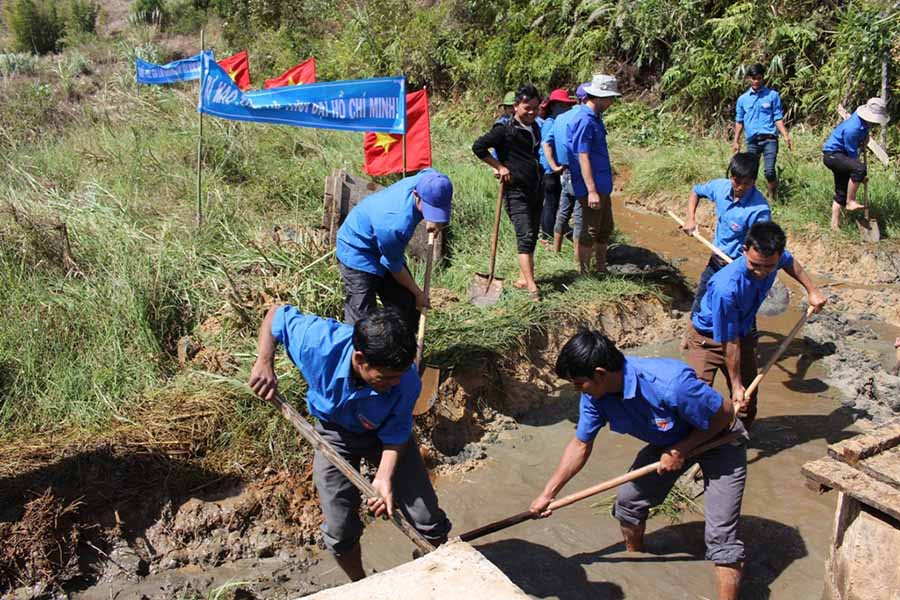 Thanh niên tham gia khơi thông dòng chảy kênh mương. Ảnh: T.B