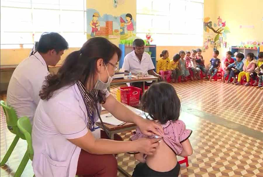  Các bác sĩ khám sàng lọc trước khi tiêm vắc xin cho học sinh Trường Mầm non xã Ia Ka. Ảnh: N.N