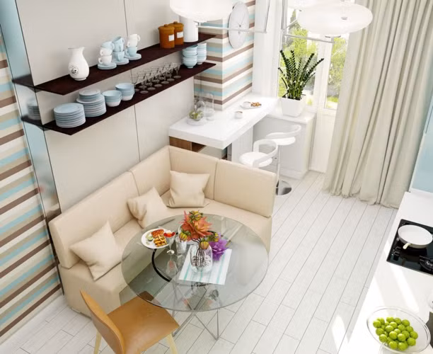  Với nhà có diện tích nhỏ, bếp ăn và bàn tiếp khách được tận dụng kê gần nhau. Trên tường là giá để đồ, cốc chén. 