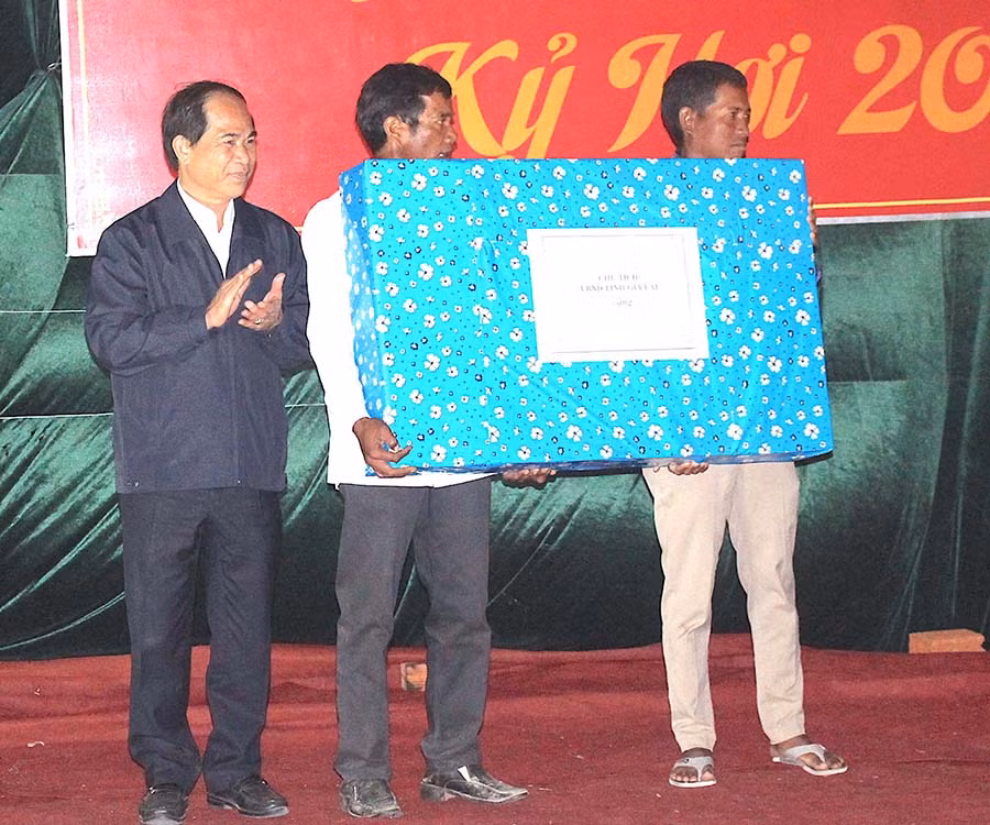 Chủ tịch UBND tỉnh Võ Ngọc Thành trao quà cho tập thể làng Hek. Ảnh: Tấn Thi