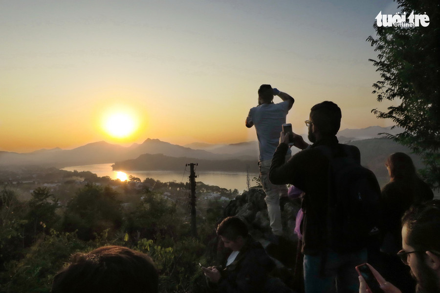  Các nhiếp ảnh gia với máy ảnh chuyên dùng, hoặc smartphone say sưa tác nghiệp ngay thời khắc đẹp nhất trong ngày - Ảnh: T.T.D.