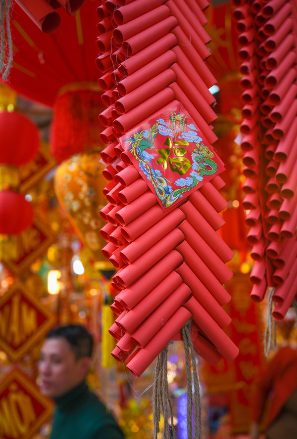 Đồ trang trí Tết năm nay có thêm mặt hàng pháo giả gần giống hình ảnh những bánh pháo ngày xưa. Loại pháo này làm từ giấy cuộn tròn và nối với nhau bằng dây, có giá khoảng vài chục nghìn tùy kích thước. David, du khách Canada lần đầu đến Việt Nam, kể về cảm nhận của mình: 