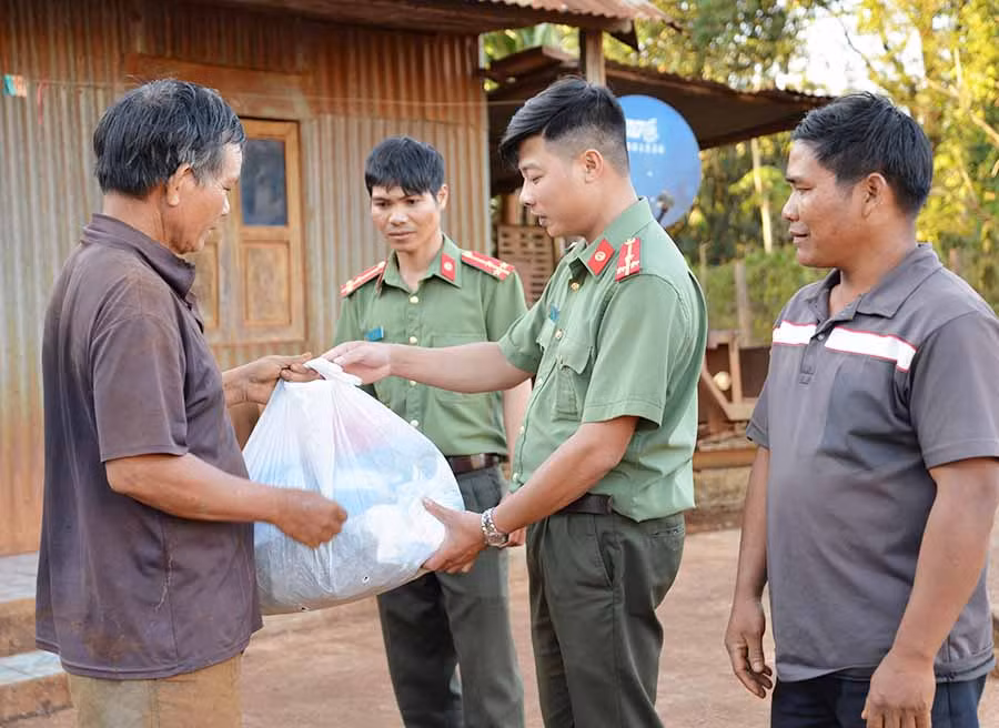  Cán bộ Phòng An ninh Đối nội Công an tỉnh tặng quà cho gia đình có hoàn cảnh khó khăn. Ảnh: H.T