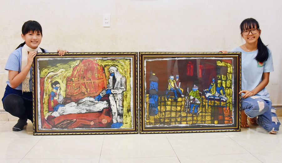 Từ trái sang: Em Đinh Ngọc Hoàng Mai và Phan Minh Hà Vy bên những tác phẩm chuẩn bị tham dự Triển lãm mỹ thuật khu vực Nam miền Trung-Tây Nguyên lần thứ 26. Ảnh: Phương Duyên