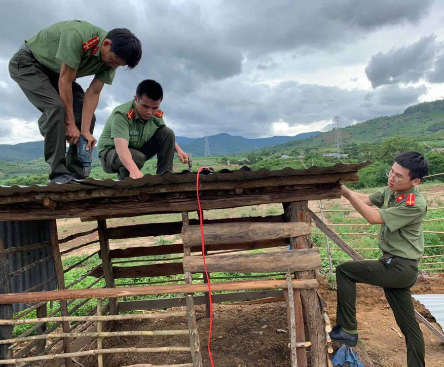Công an huyện Đak Pơ giúp đỡ người dân xây dựng chuồng trại chăn nuôi. Ảnh: Lê Anh Công an huyện Đak Pơ giúp đỡ người dân xây dựng chuồng trại