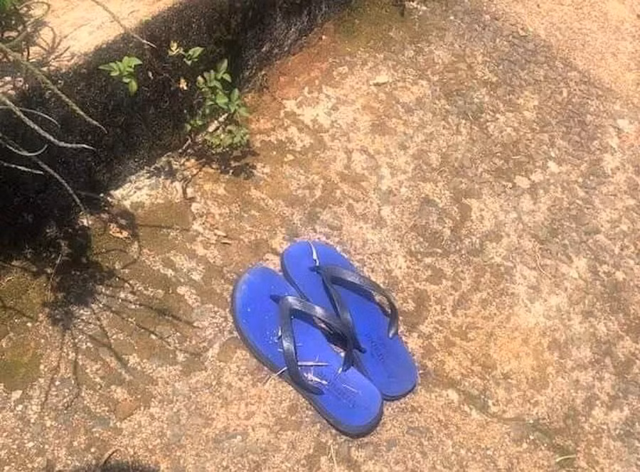 Đôi dép tông màu xanh nghi của nạn nhân được phát hiện trên bơ hồ Mai Thành