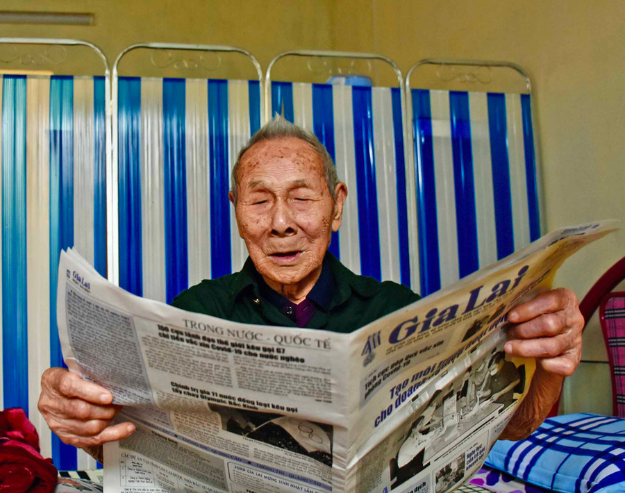 Ảnh 3: Dù đã 99 tuổi nhưng cụ Tấn vẫn đọc báo rất tốt.