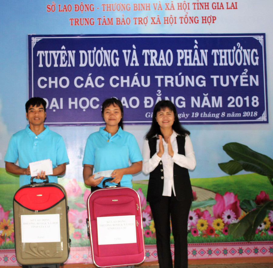 Lãnh đạo sở LĐ-TB và XH trao thuwongr cho 2 em đậu Đại học và Cao đẳng. Ảnh: Đinh Yến