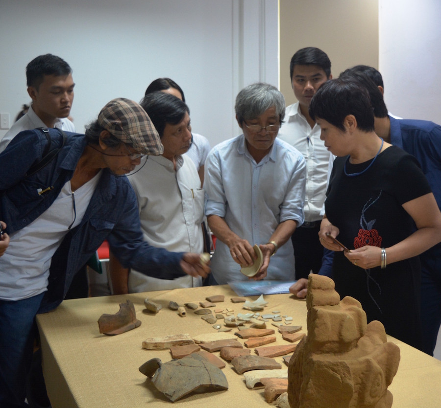 Các nhà khoa học giới thiệu về những hiện vật Chăm sau quá trình khai quật. Ảnh: VGP/Lưu Hương