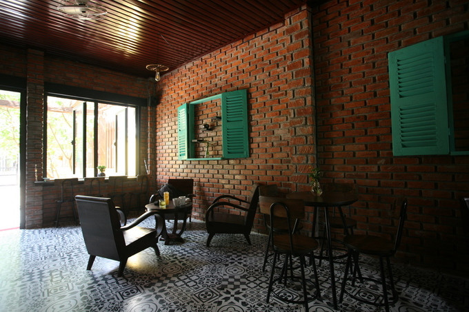 Đây là ngôi nhà mới dựng lên bên cạnh ngôi nhà cũ - nơi ở và dạy học của chủ nhân. Khoảng sân phía trước có cây xanh tỏa bóng mát và ngập tràn nắng gió. Không gian bên trong vừa phải nhưng không có vách ngăn khiến quán thoáng rộng hơn.