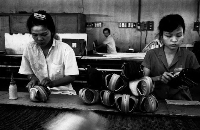  Hai nữ công nhân đang làm việc tại một xưởng giày dép.