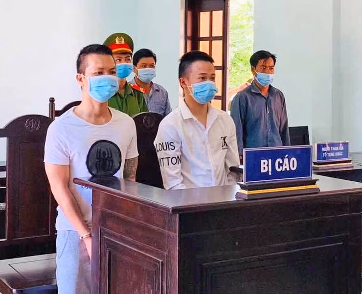 Dung (bìa trái) và Luận tại tòa. Ảnh: 