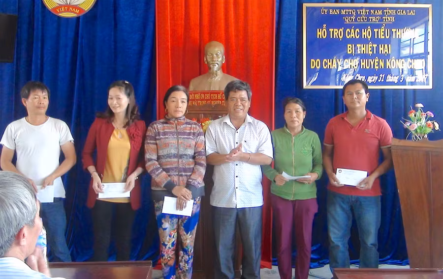 Trao tiền hỗ trợ cho các tiểu thương. Ảnh: Hồng Thi