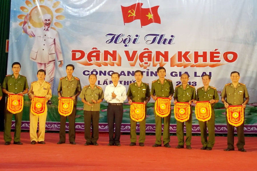 Lãnh đạo Ban Dân vận Tỉnh ủy và Công an tỉnh tặng cờ lưu niệm cho các đội dự thi. Ảnh: Thanh Nhật